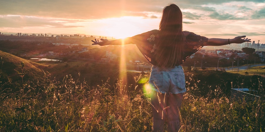 Woman standing in shining sun.